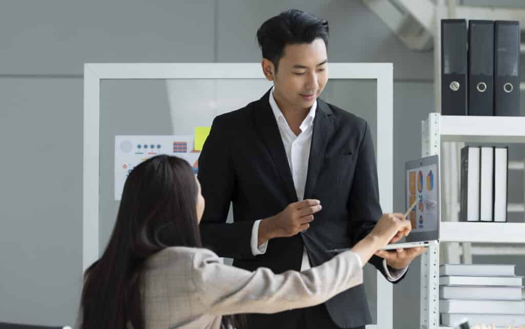 manager working with an employee on a project