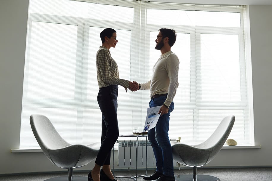Business partners handshaking in office