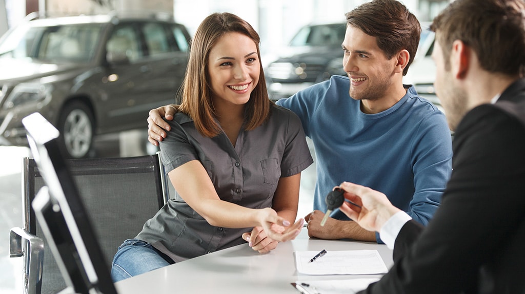 A happy couple buys a car together.