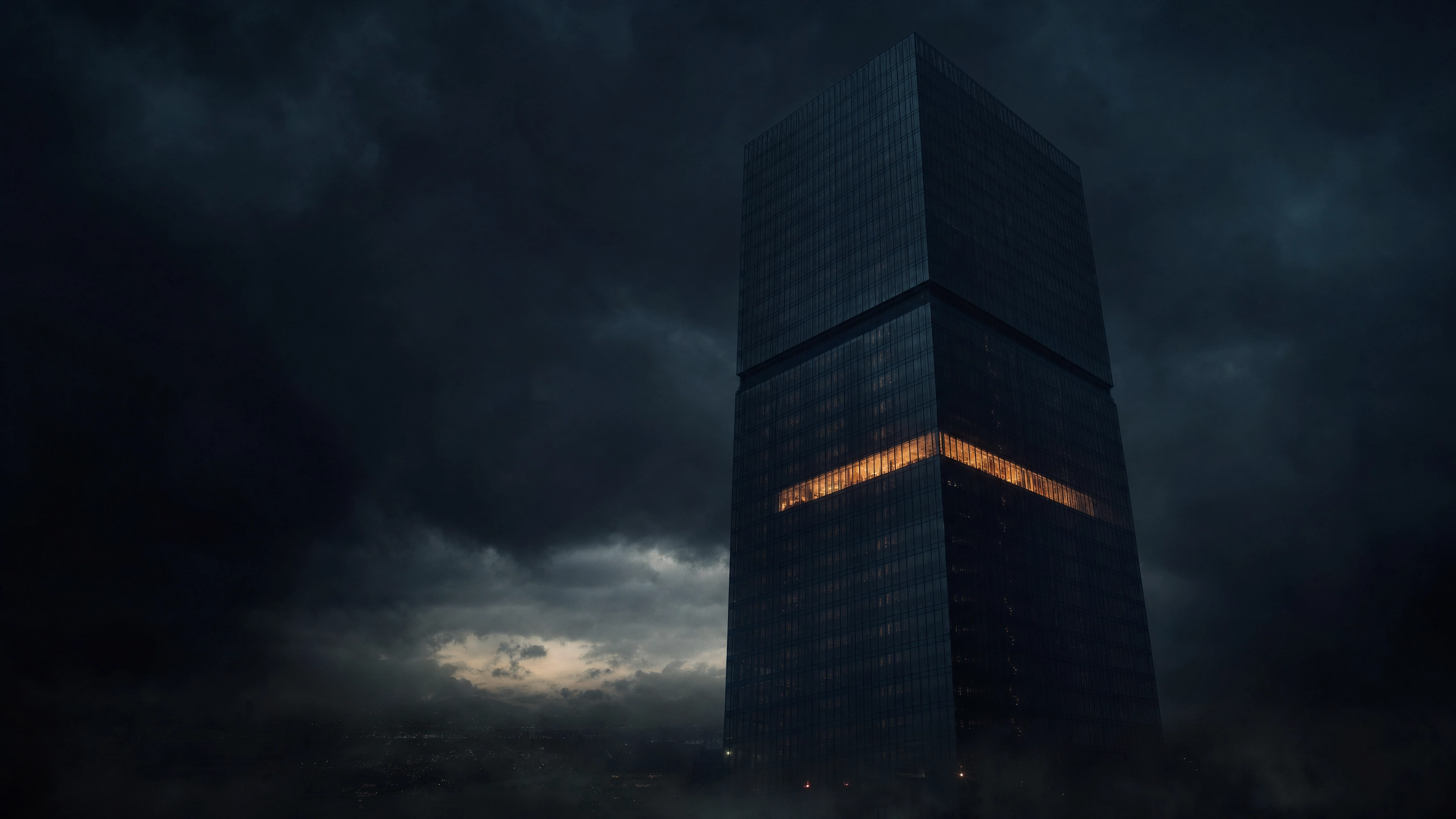 Single glass office tower at dusk with nearly all windows dark except one glowing floor, storm clouds gathering behind it